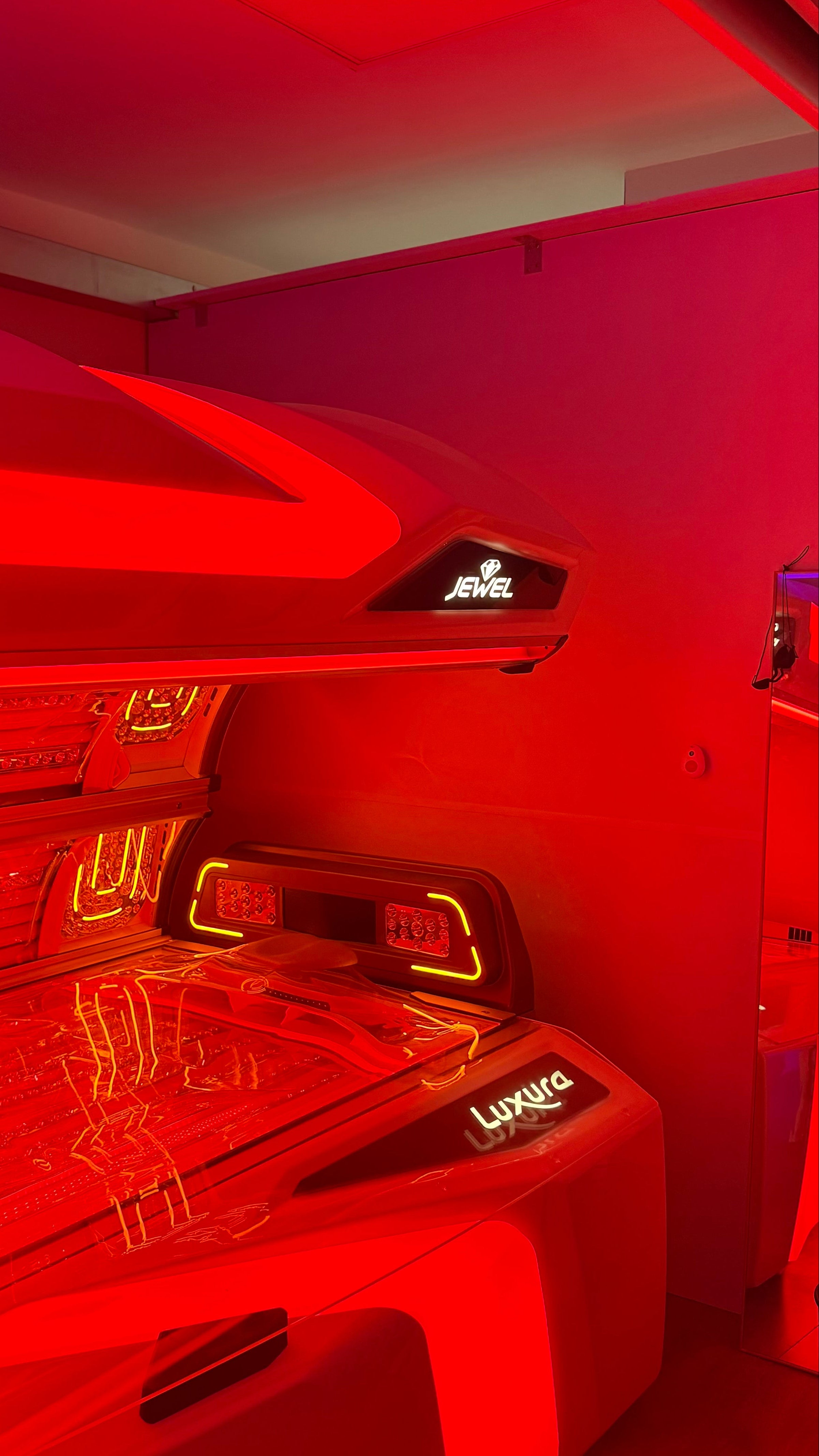 Tanning booth with red light inside a room